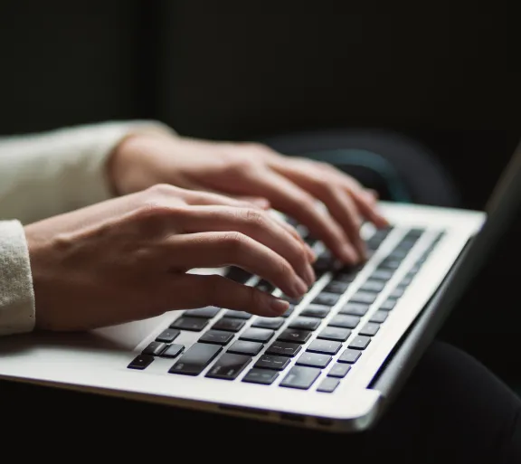 person typing on laptop
