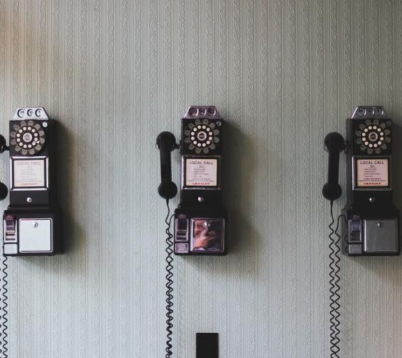 three old wall telephones