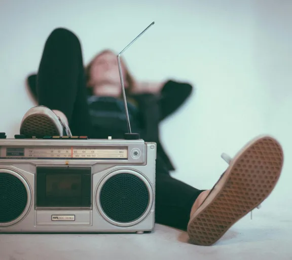 woman with foot on stereo