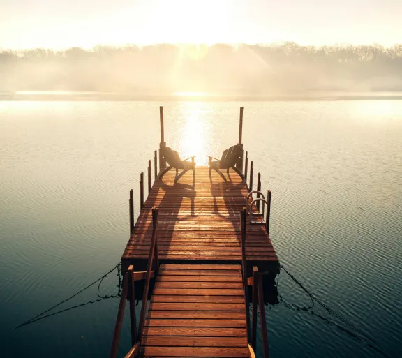 wooden dock leading out to a lake