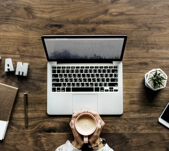 laptop on wood desk