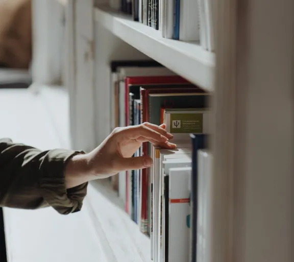 person touching bookshelf