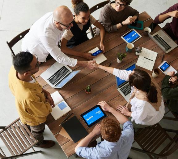 coworkers working at laptops on one table