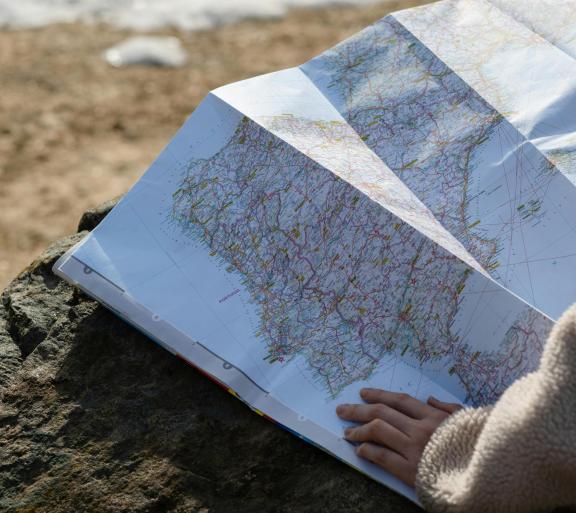 hand on map