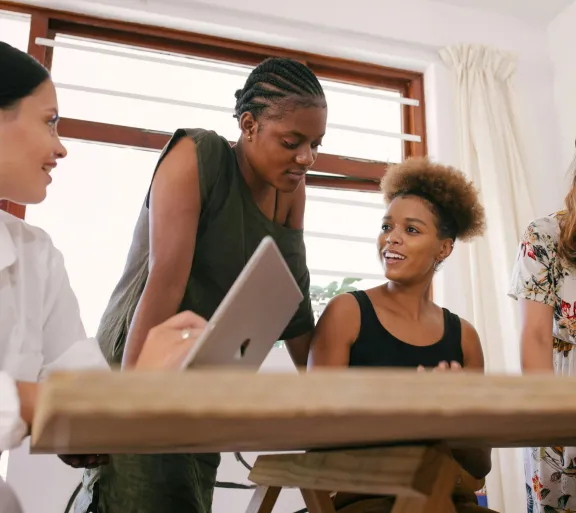 women gathered around computer
