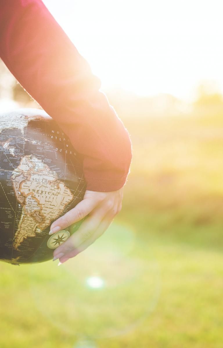 person holding globe