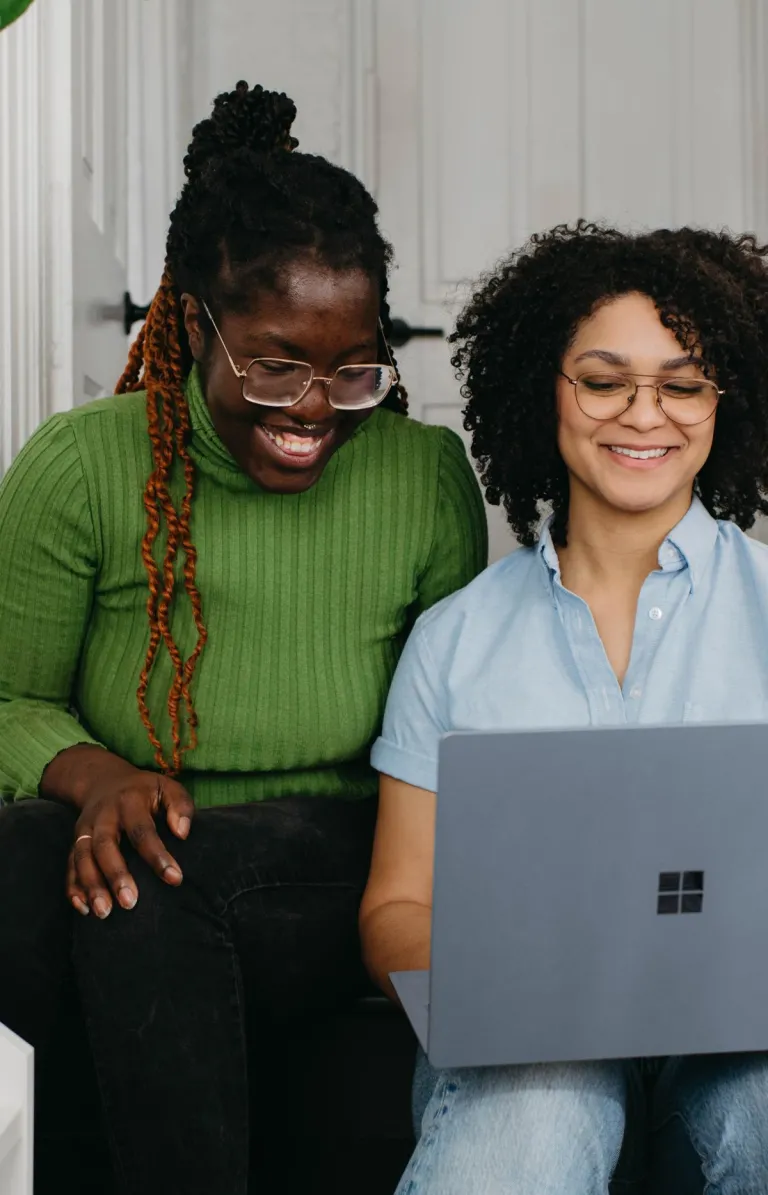 two women looking at a computer