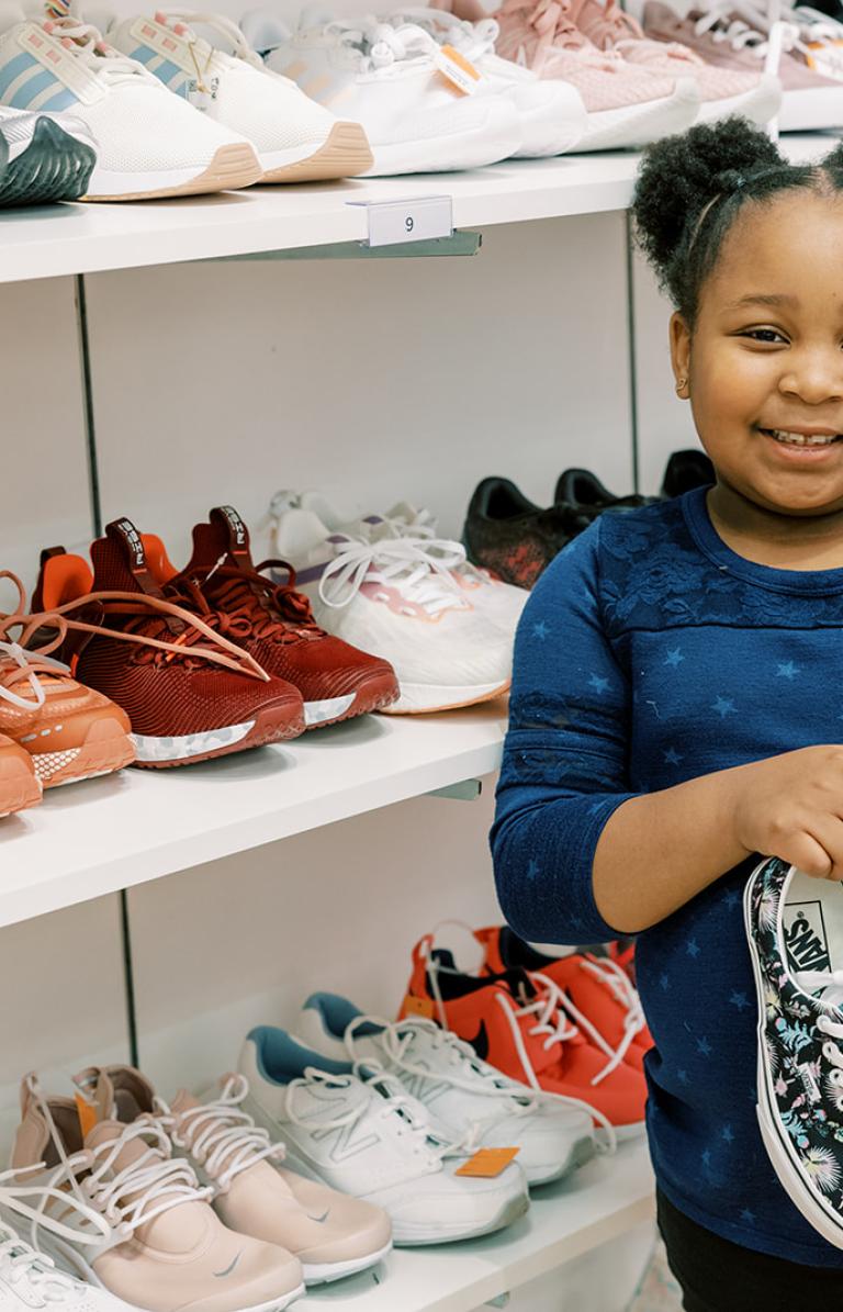 girl holding shoes