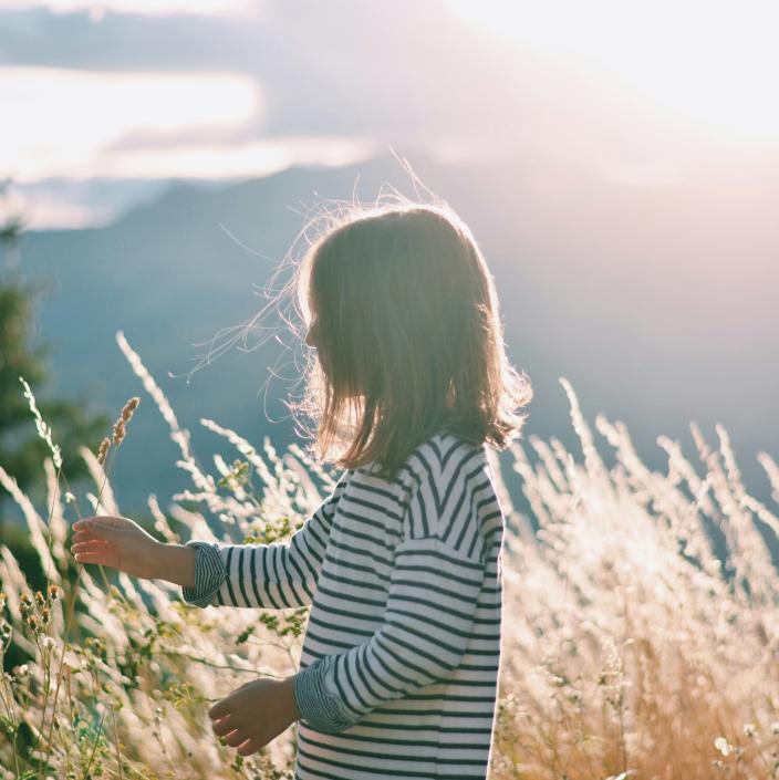 child in tall grass