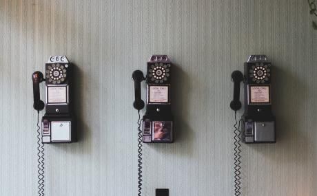 three old wall telephones
