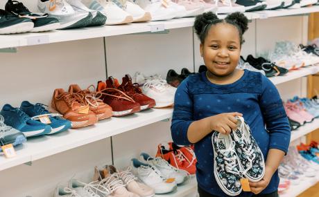 girl holding shoes