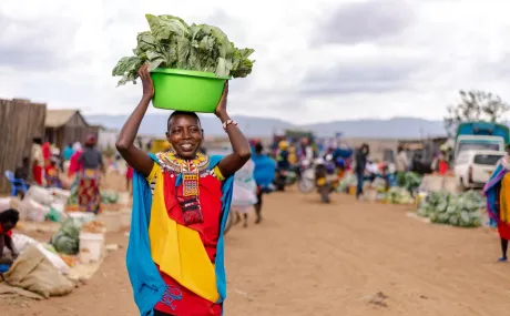 woman carrying bowl of lettuce
