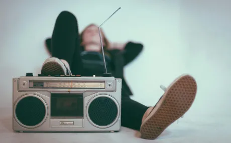 woman with foot on stereo