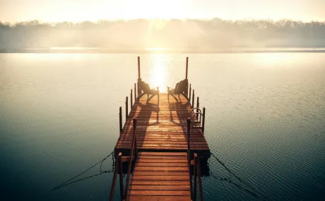 wooden dock leading out to a lake