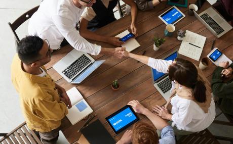 coworkers working at laptops on one table