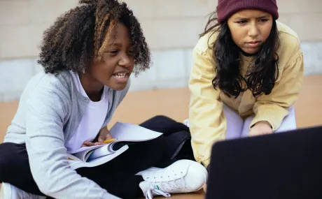 two girls using a computer