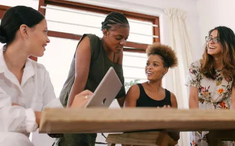 women gathered around computer