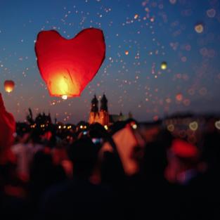 a heart shaped lantern floating into the air
